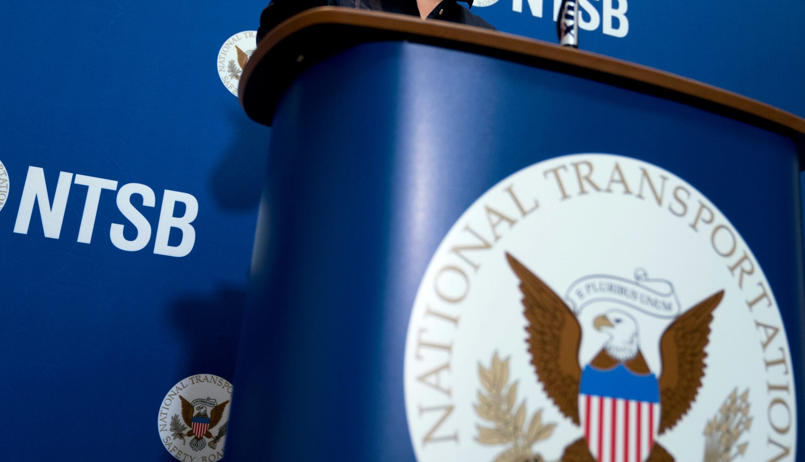 <i>Andrew Harnik/AP via CNN Newsource</i><br/>The National Transportation Safety Board logo and signage seen at a news conference at NTSB headquarters in Washington