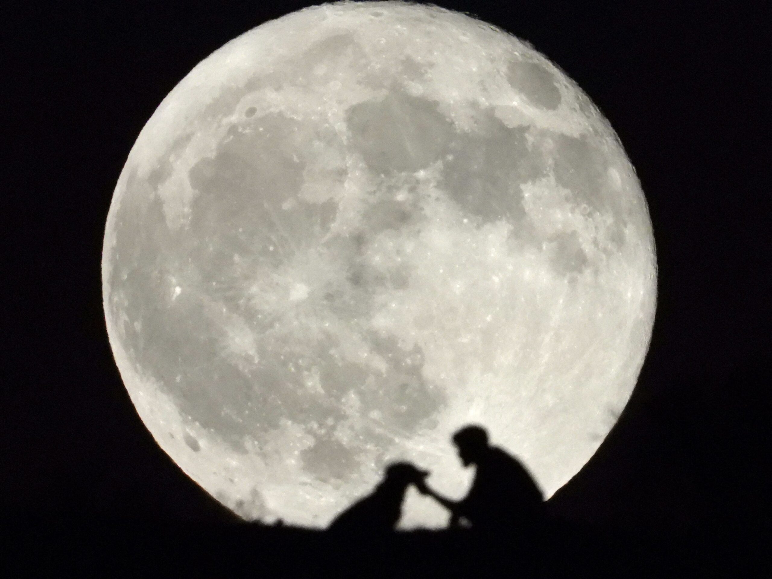 <i>Borja Suarez/Reuters via CNN Newsource</i><br/>A sturgeon full moon dominates the sky over Arguineguin