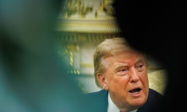 Trump answers questions from reporters in the Oval Office of the White House in Washington
