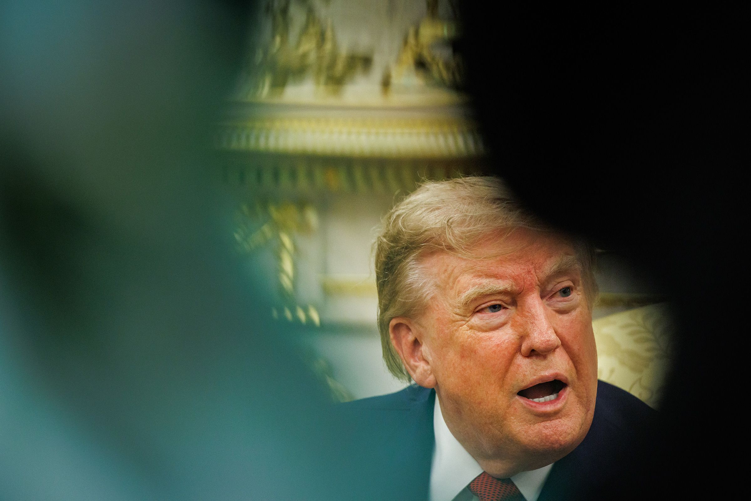 <i>Samuel Corum/Sipa USA via CNN Newsource</i><br/>Trump answers questions from reporters in the Oval Office of the White House in Washington