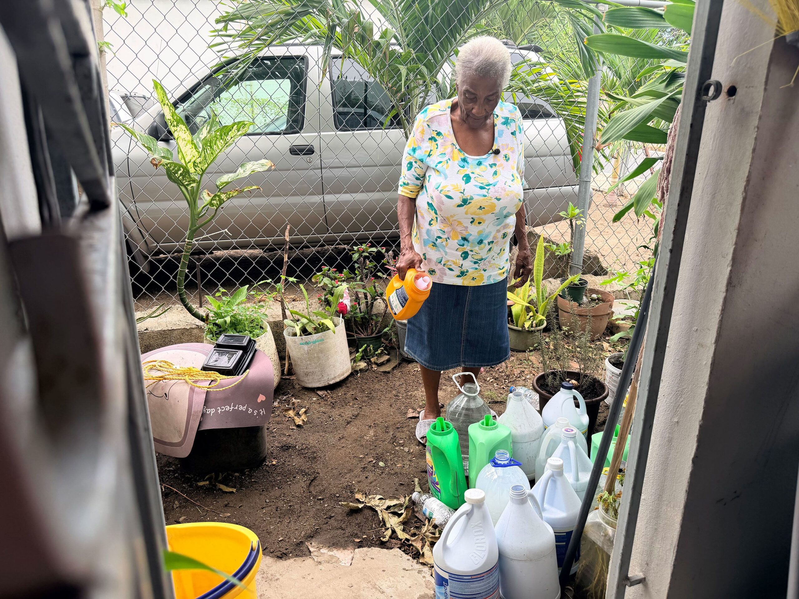 <i>Ricardo Arduengo/AFP via Getty Images via CNN Newsource</i><br/>A person fills a container from a natural spring in Trujillo Alto on August 6.