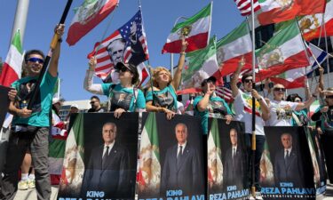 A protester waves an Iranian flag and shouts slogans during a demonstration against US military action in Iran near the White House