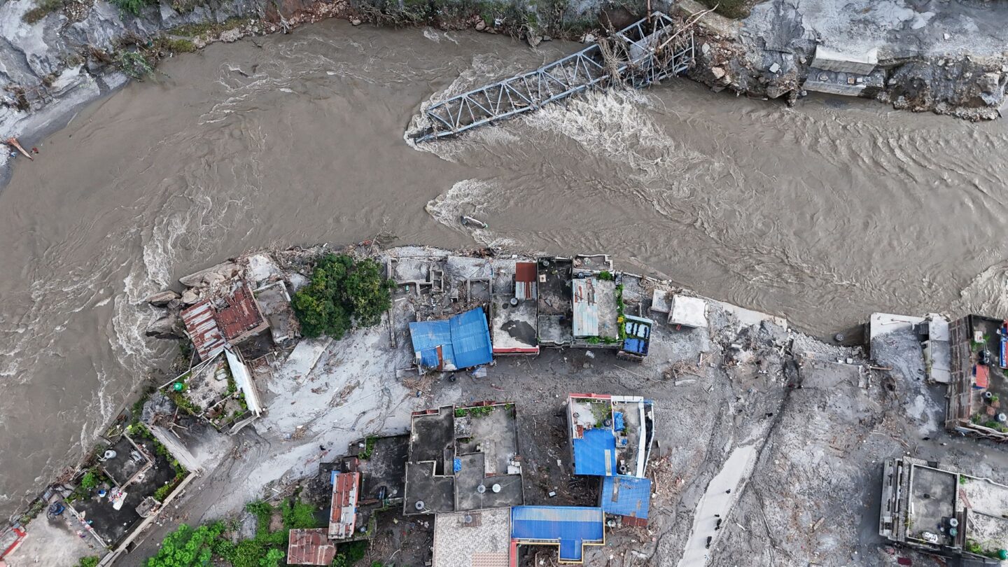 <i>Ritesh Shukla/Getty Images via CNN Newsource</i><br/>An aerial view shows a collapsed bridge and damaged settlements debris and mud covering an area following flash floods on August 28