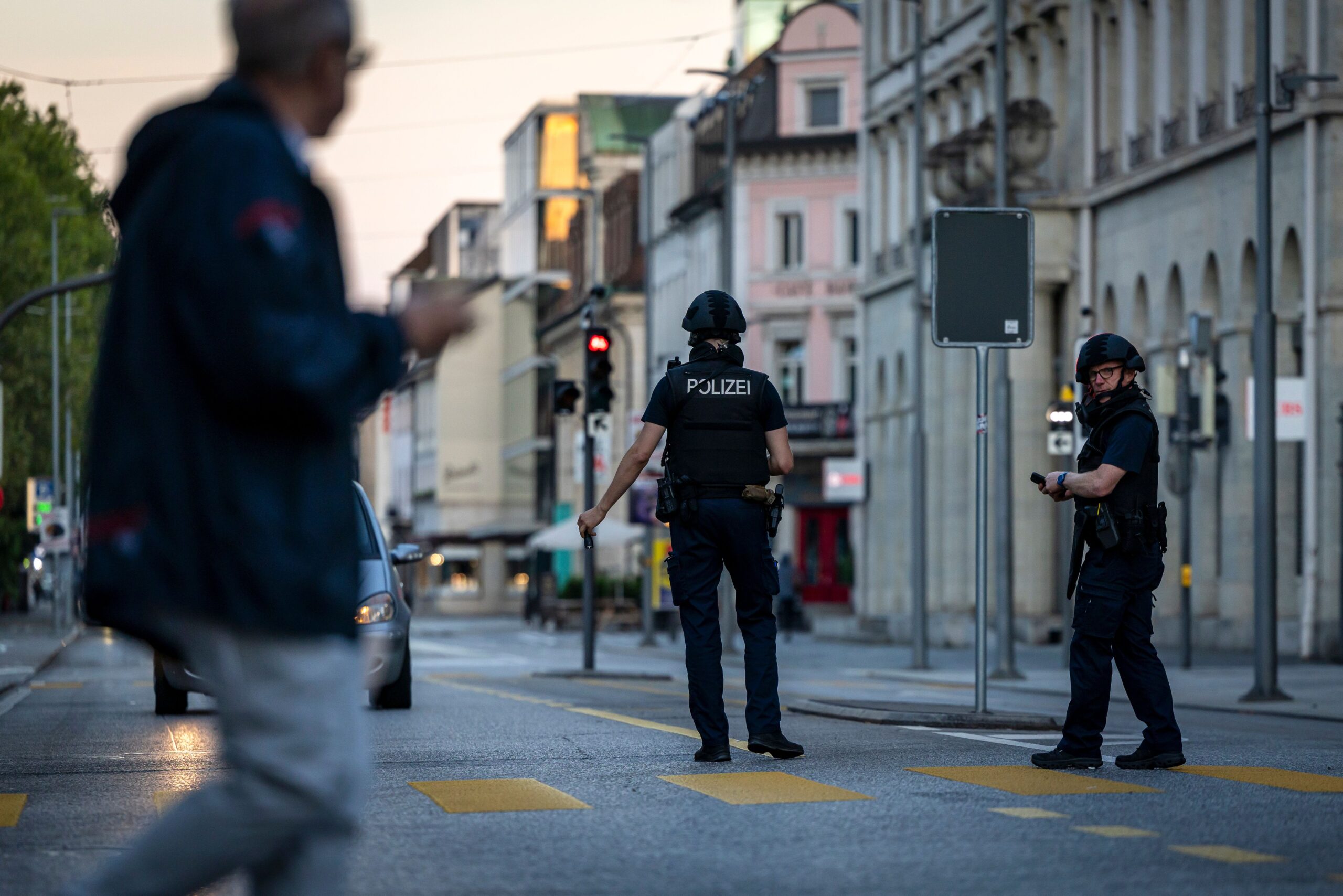<i>Michael Buholzer/Keystone/AP via CNN Newsource</i><br/>Police officers patrol a street following a shooting at a rave in downtown Aarau