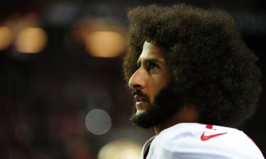 Colin Kaepernick of the San Francisco 49ers looks on from the sidelines against the Atlanta Falcons in December 2016 in Atlanta