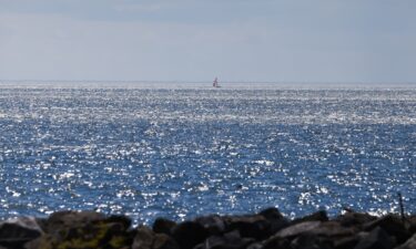 A sailboat is seen in the distance on Lake Ontario