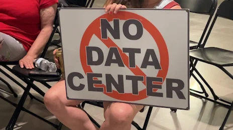 Sign by member of the audience at the State Capitol during a press conference where community members voiced concerns on data centers being built in the area. (06/17/26)