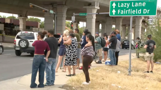 A crowd of people gather near the scene of an ICE shooting in Austin, Texas.