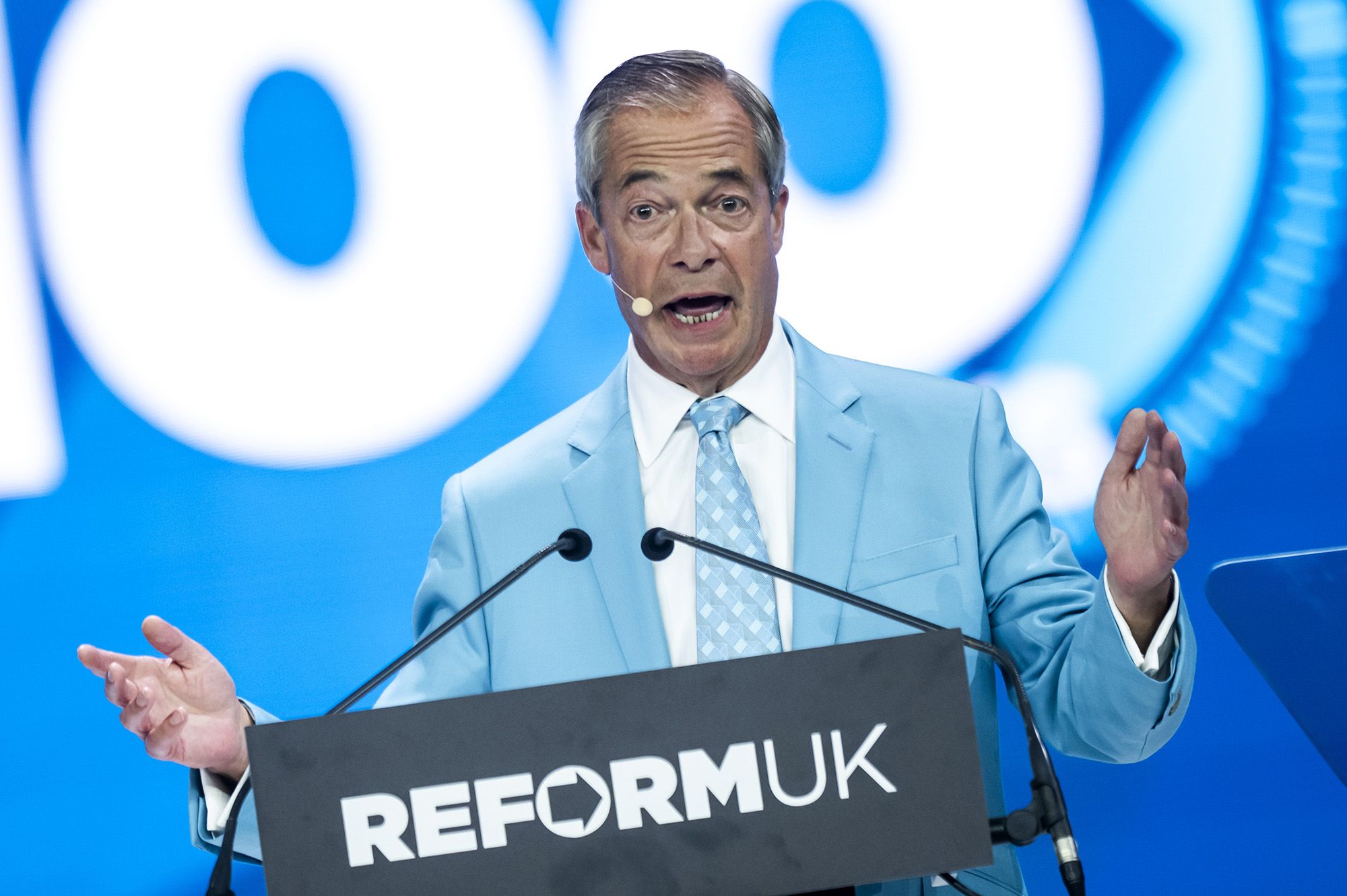 <i>Stefan Rousseau/PA/AP via CNN Newsource</i><br/>Reform UK leader Nigel Farage (center) sings the national anthem during the party's conference earlier this week