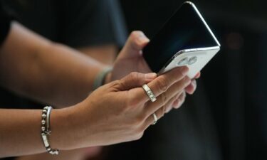 An attendee uses the iPhone Duo in Cupertino