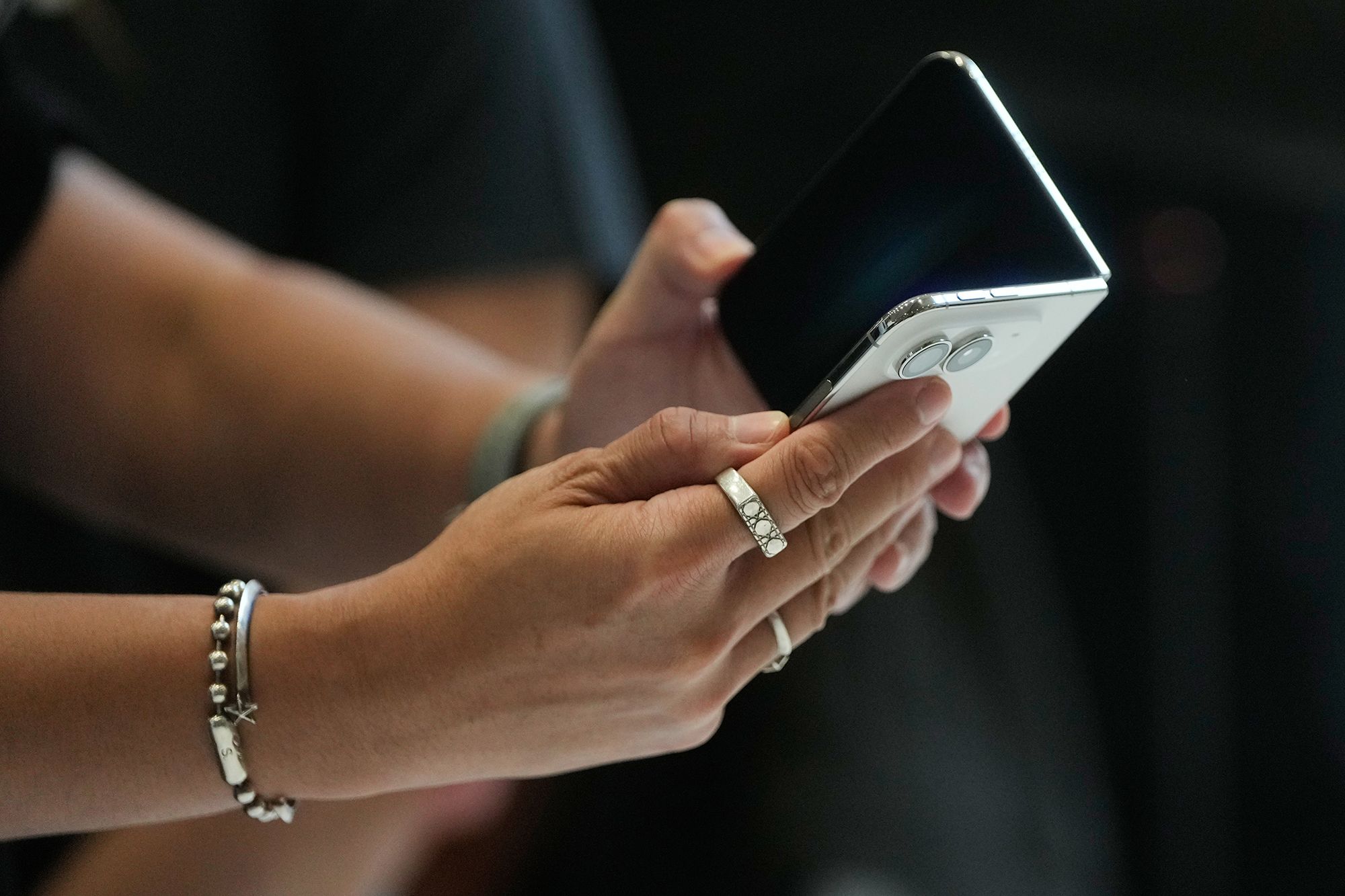 <i>Jeff Chiu/AP via CNN Newsource</i><br/>An attendee uses the iPhone Duo in Cupertino