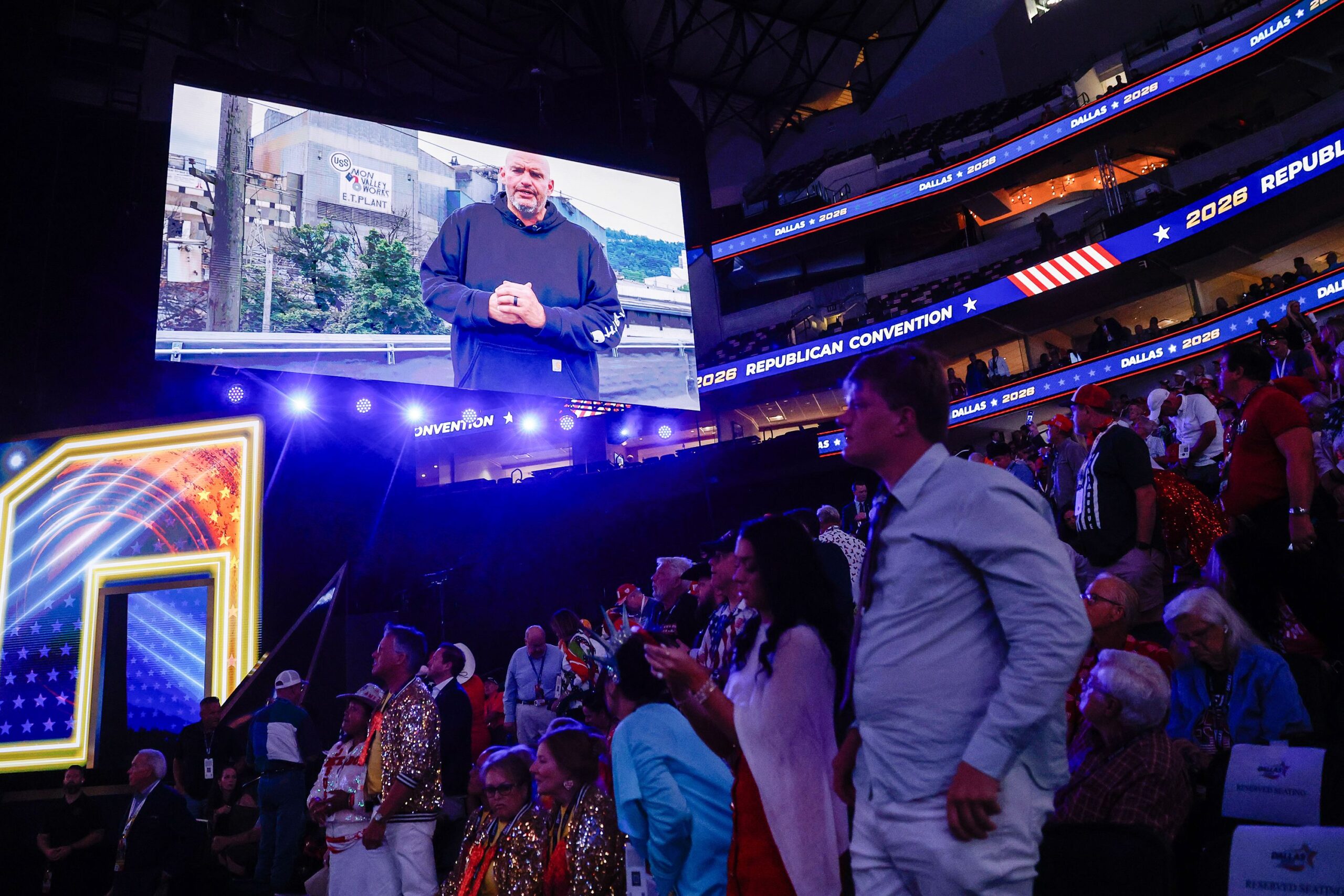 <i>Justin Sullivan/Getty Images via CNN Newsource</i><br/>People watch as U.S. Sen. John Fetterman (D-PA) appears on a video to endorse U.S. Sen. David McCormick (R-PA) on the first day of the 2026 Republican National Convention at the American Airlines Center in Dallas