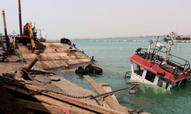 A sunken vessel is seen at the surface of the water in the port of Mocha the day after an attack by the Houthis on August 9. Strikes by the Iran-backed Houthi rebels have been happening on Yemen's west coast for weeks.