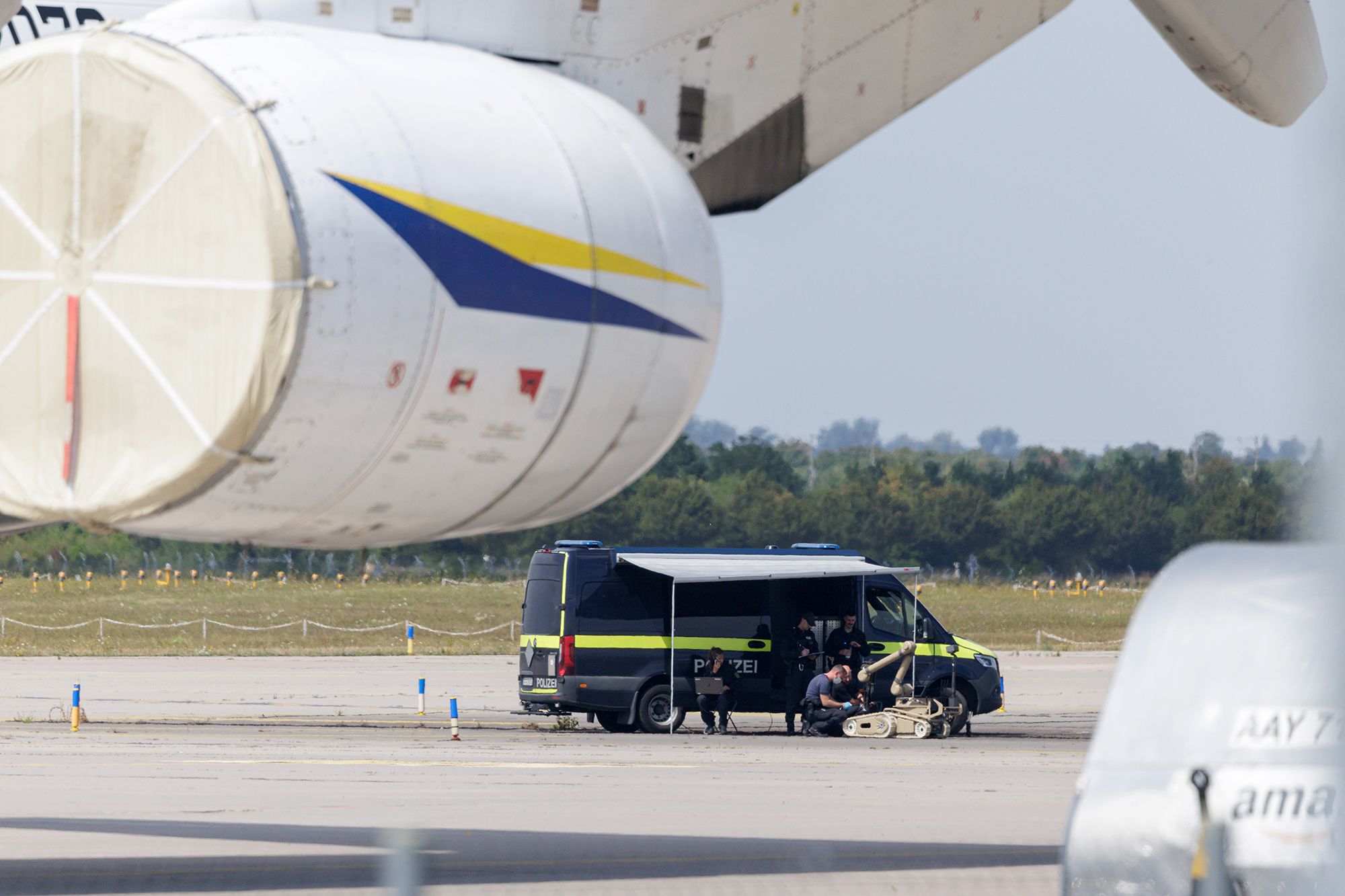 <i>Hendrik Schmidt/picture alliance/Getty Images via CNN Newsource</i><br/>Police officers pictured searching a field at the Leipzig/Halle Airport for evidence.