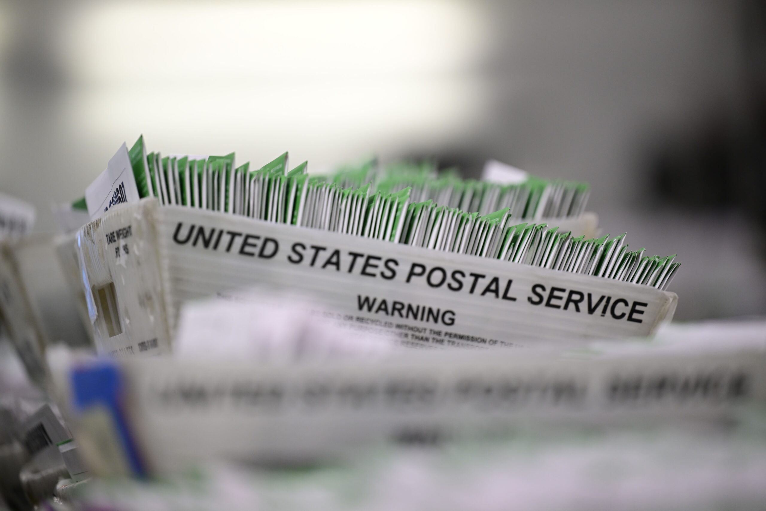 <i>Weston Hancock/SOPA Images/SIPAPRE/AP via CNN Newsource</i><br/>United States postal Services warning document seen during the ballots processing at the Los Angeles County Ballot Processing Center on June 3