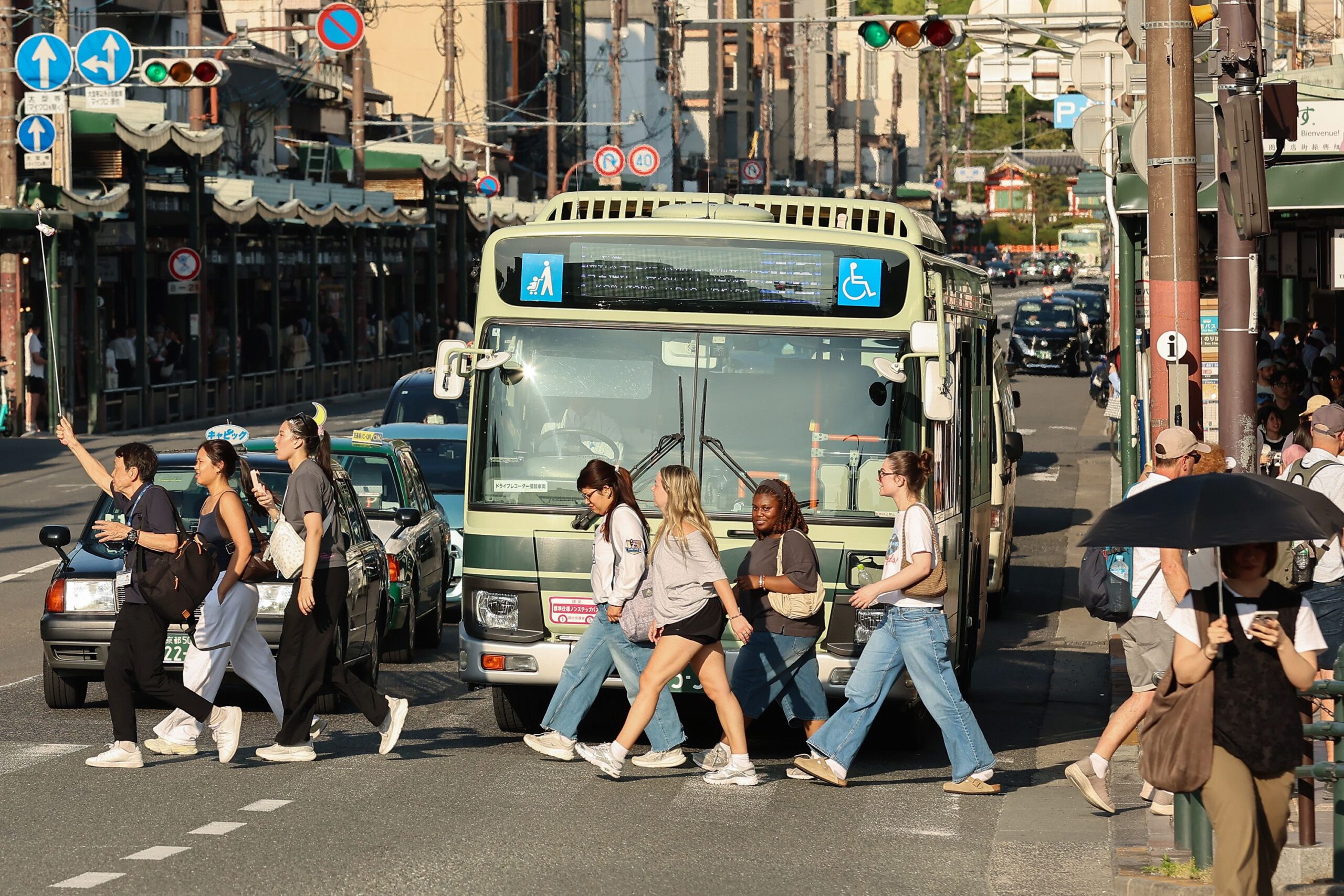 <i>Buddhika Weerasinghe/Getty Images via CNN Newsource</i><br/>A tourist group crosses the street near the Yasaka Shrine in Osaka.