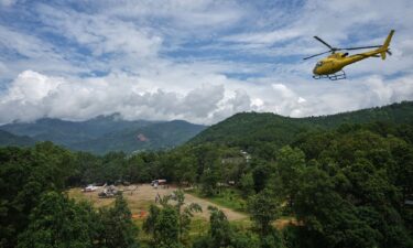 Private and military helicopters are deployed to rescue people stranded in areas cut off by flash flooding in Nepal's Nuwakot district on Monday.