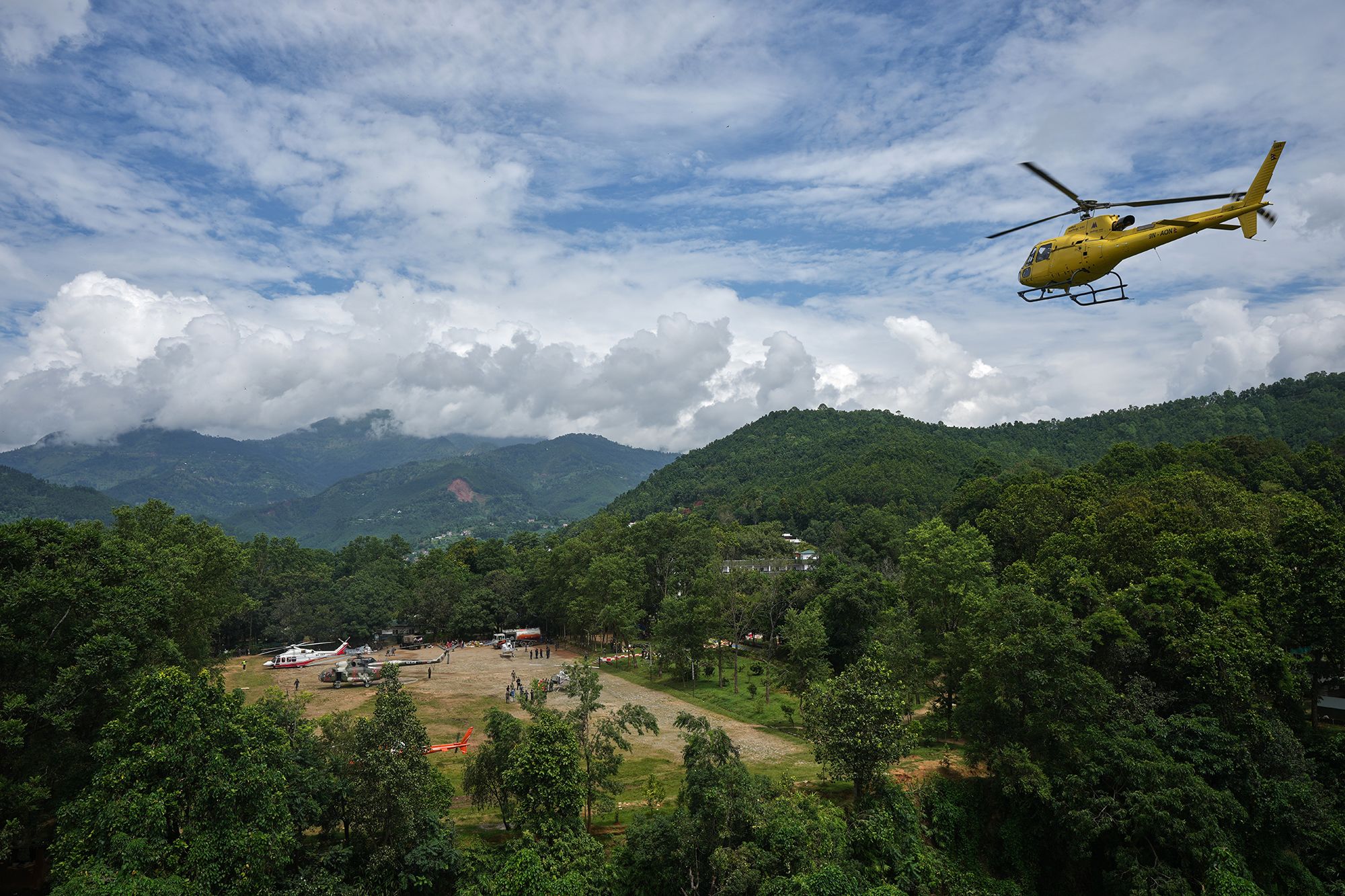 <i>Rajesh Kumar Singh/AP via CNN Newsource</i><br/>Private and military helicopters are deployed to rescue people stranded in areas cut off by flash flooding in Nepal's Nuwakot district on Monday.