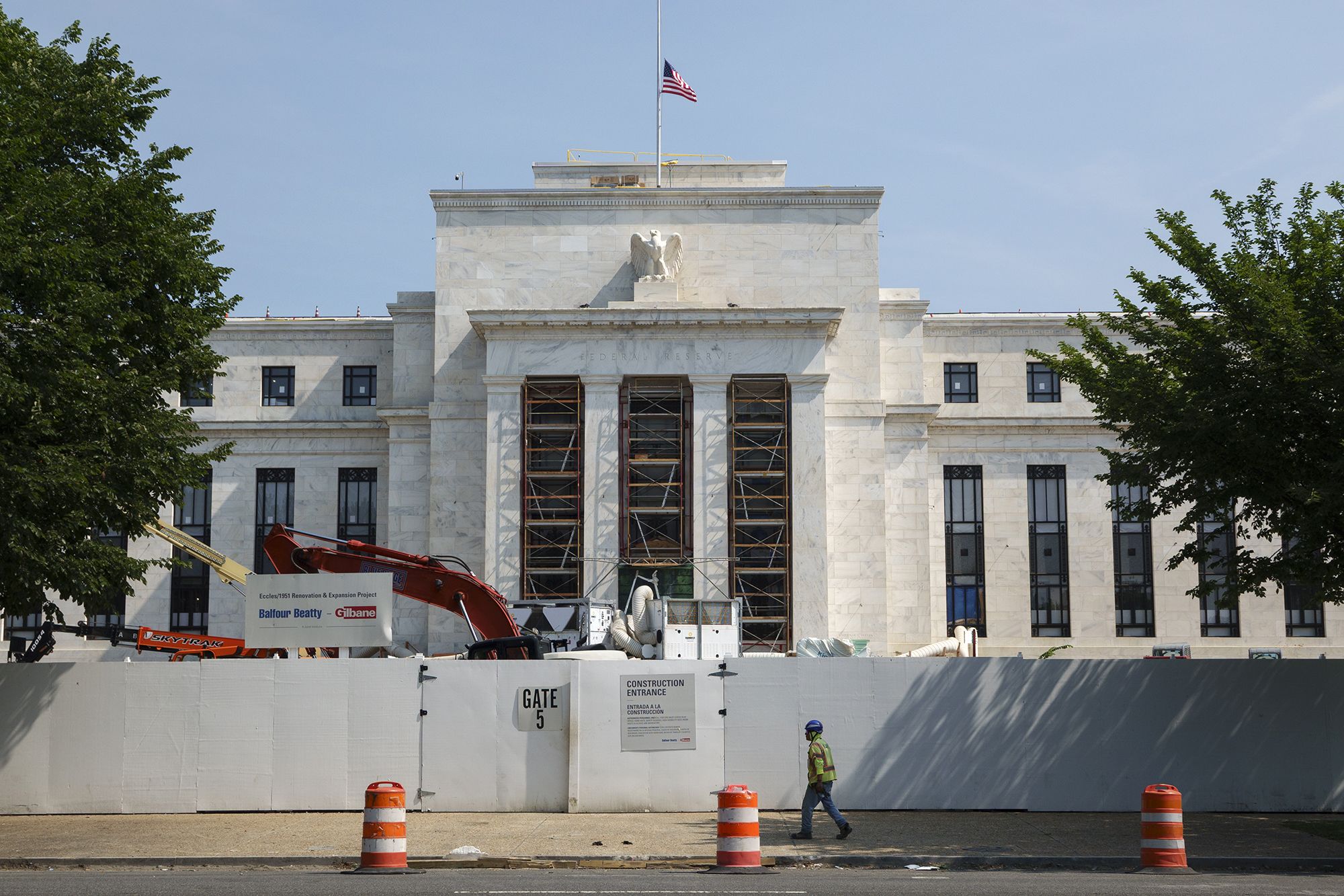 <i>Kevin Carter/Getty Images via CNN Newsource</i><br/>A construction worker walks by the Federal Reserve Building in Washington