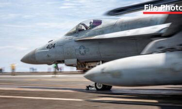 A fighter jet launches off the flight deck of the USS George Washington