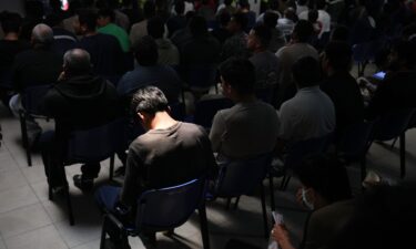 People removed from the US wait inside a processing center at Guatemala City's La Aurora airport on August 21.