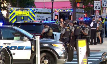 Law enforcement responds near the scene of a reported officer-involved shooting in downtown Minneapolis on Wednesday