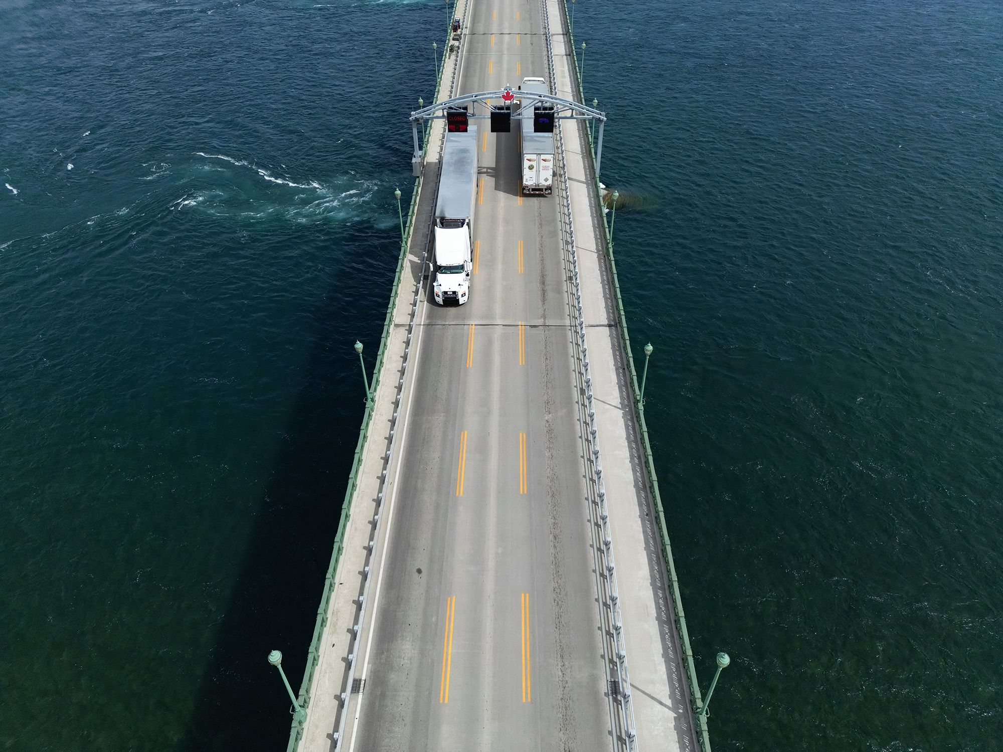 <i>Cole Burston/AFP/Getty Images via CNN Newsource</i><br/>This aerial view shows trucks passing over the Peace Bridge between Canada and the US in Fort Erie