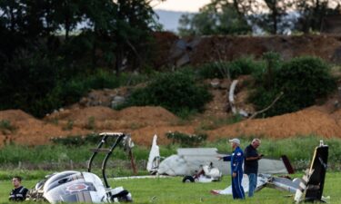 Authorities investigate a crash between a Pennsylvania State Police helicopter and a small plane at the Carlisle airport in Carlisle