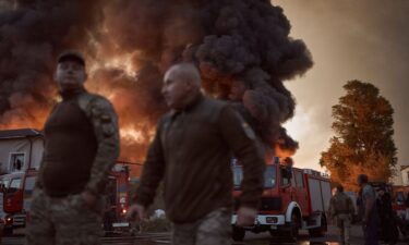A firefighter listens to the sounds of a flying drone as he hides in a shelter in Kyiv