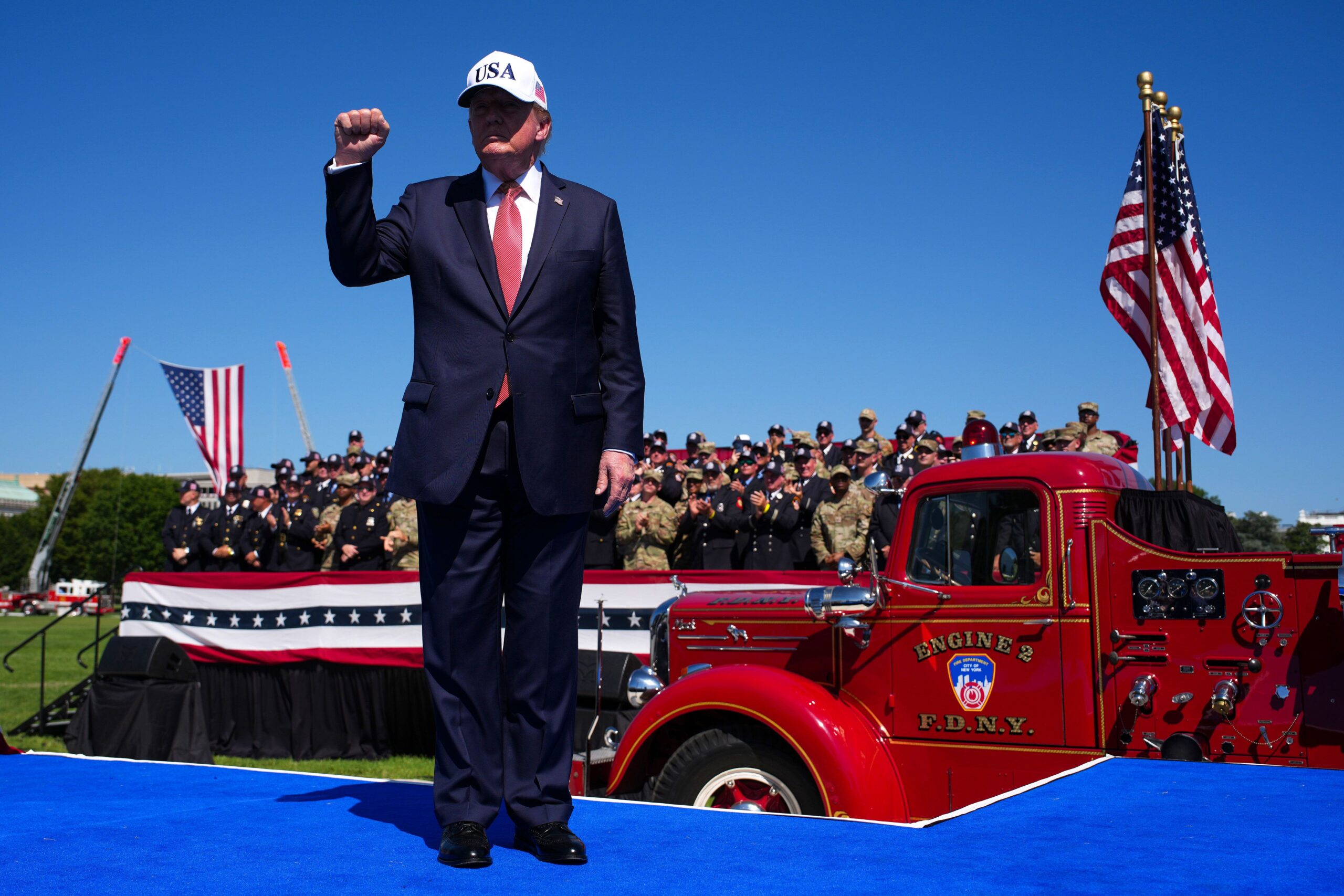<i>Finn Gomez/Getty Images via CNN Newsource</i><br/>US service members cheer as President Donald Trump departs after speaking during a 