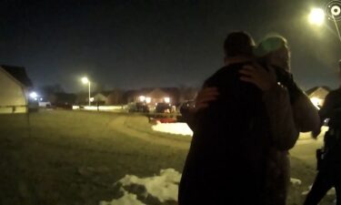 Caleb Flynn embraces his mother-in-law as law enforcement investigate the killing of his wife in February 2026.