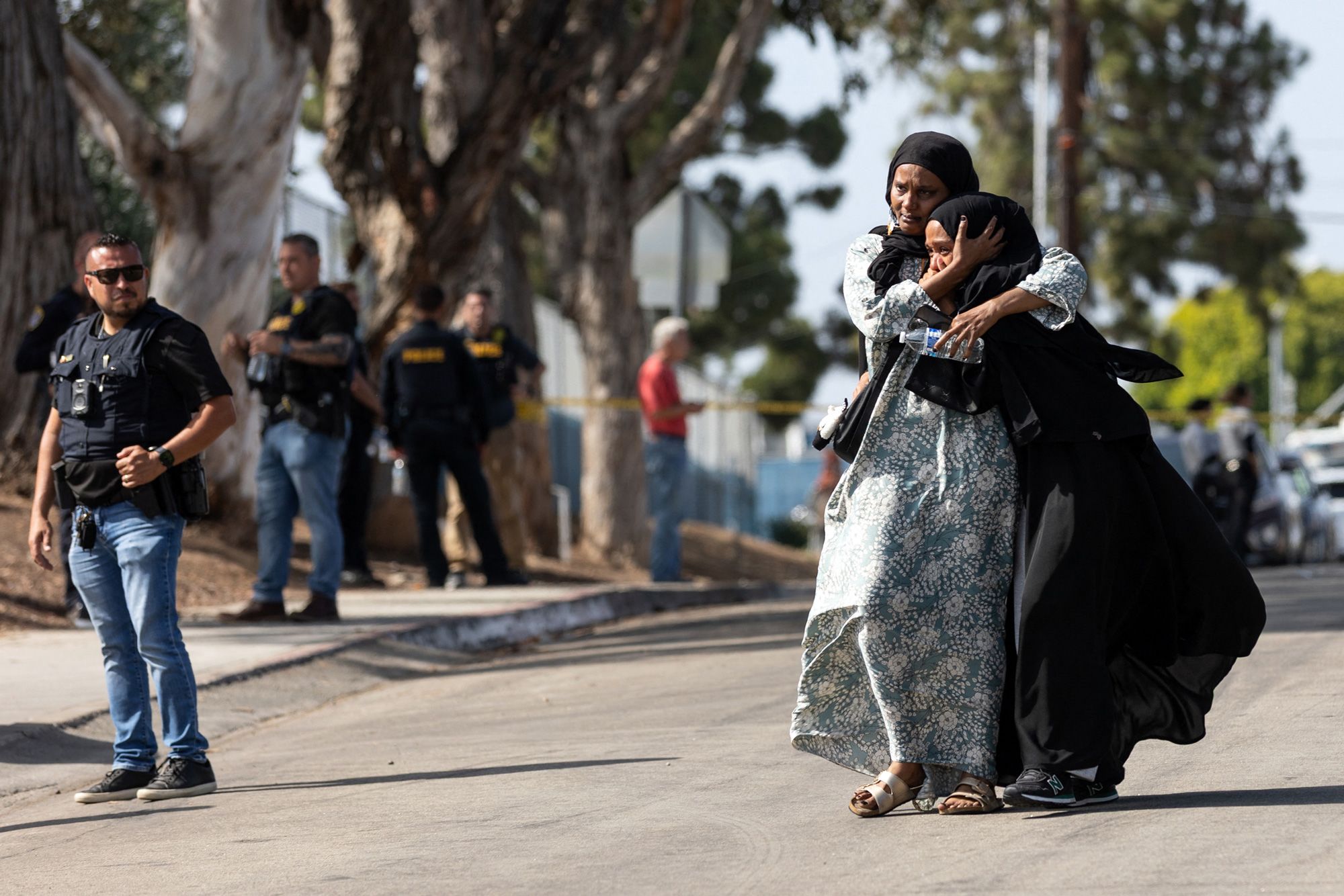 <i>Zoë Meyers/AFP/Getty Images via CNN Newsource</i><br/>Two women react as they leave a reunification center following the shooting at the Islamic Center of San Diego in southern California