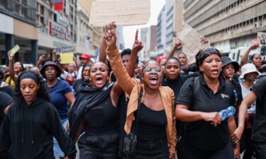 Protesters sing and chant during a demonstration calling for gender-based violence and femicide to be declared a national disaster at the Union Buildings in Pretoria on April 11
