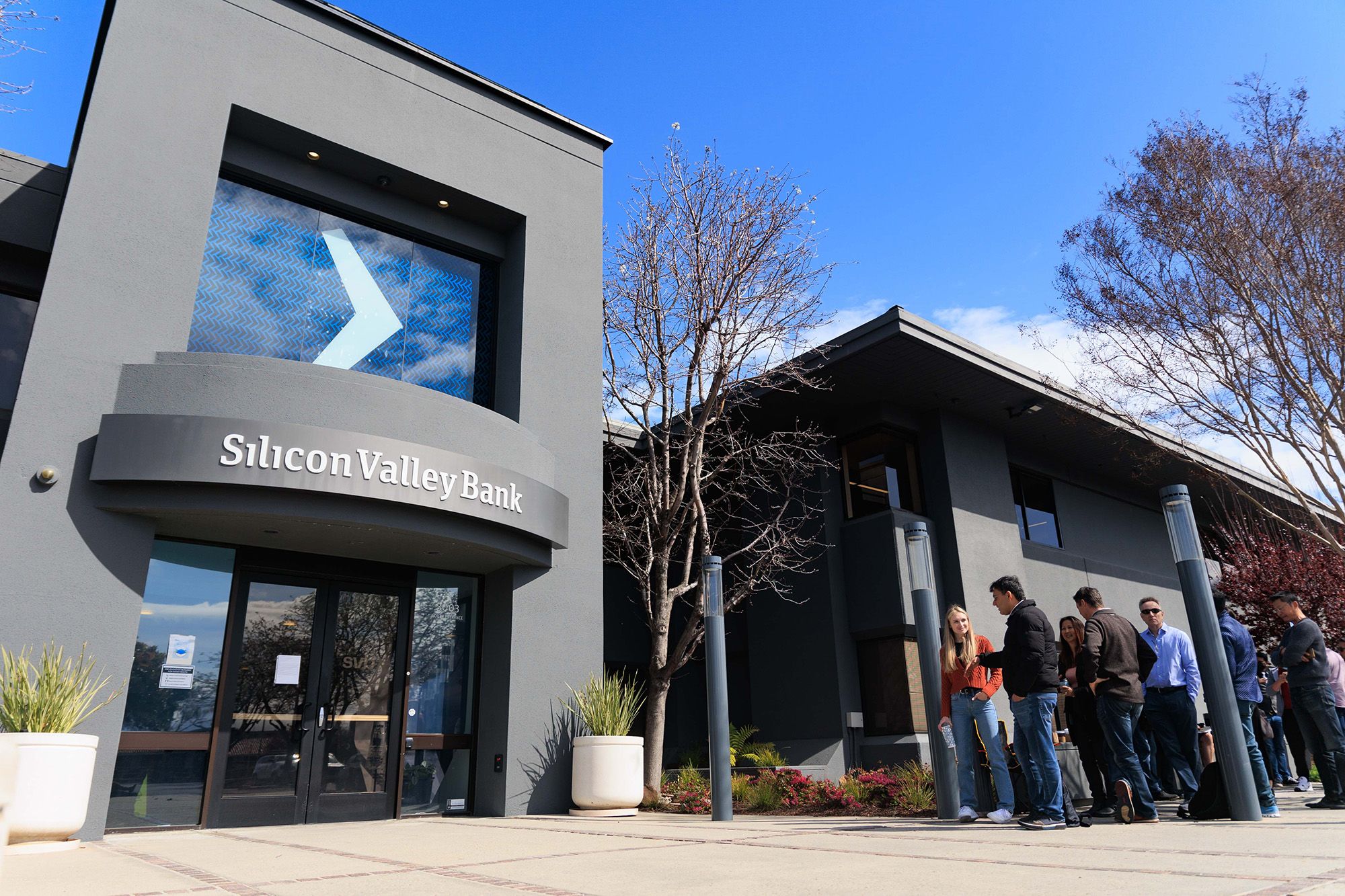 <i>Nikolas Liepins/Anadolu Agency/Getty Images via CNN Newsource</i><br/>People wait outside the Silicon Valley Bank headquarters in Santa Clara