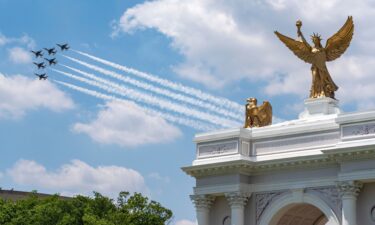 The Air Force Thunderbirds fly past a mockup of President Donald Trump's proposed Triumphal Arch at the Great American State Fair on the National Mall as part of "Wings of Freedom" day
