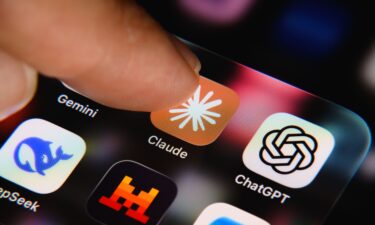 A finger is about to tap the Claude app icon on a smartphone screen in Creteil