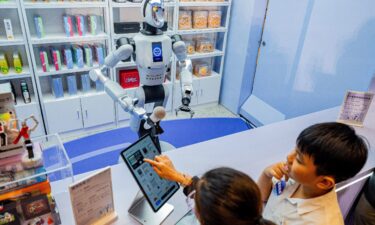 A humanoid robot is seen working with packages during the World Artificial Intelligence Conference in Shanghai