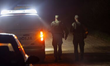 Lithuanian soldiers secure the area where a NATO fighter jet shot down a drone equipped with an explosive device early on Tuesday morning near Pratkunai village