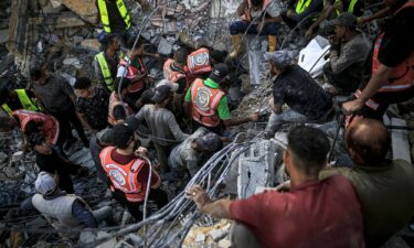 Rescue workers remove the bodies of victims from the rubble of a collapsed building in Gaza City on Wednesday.