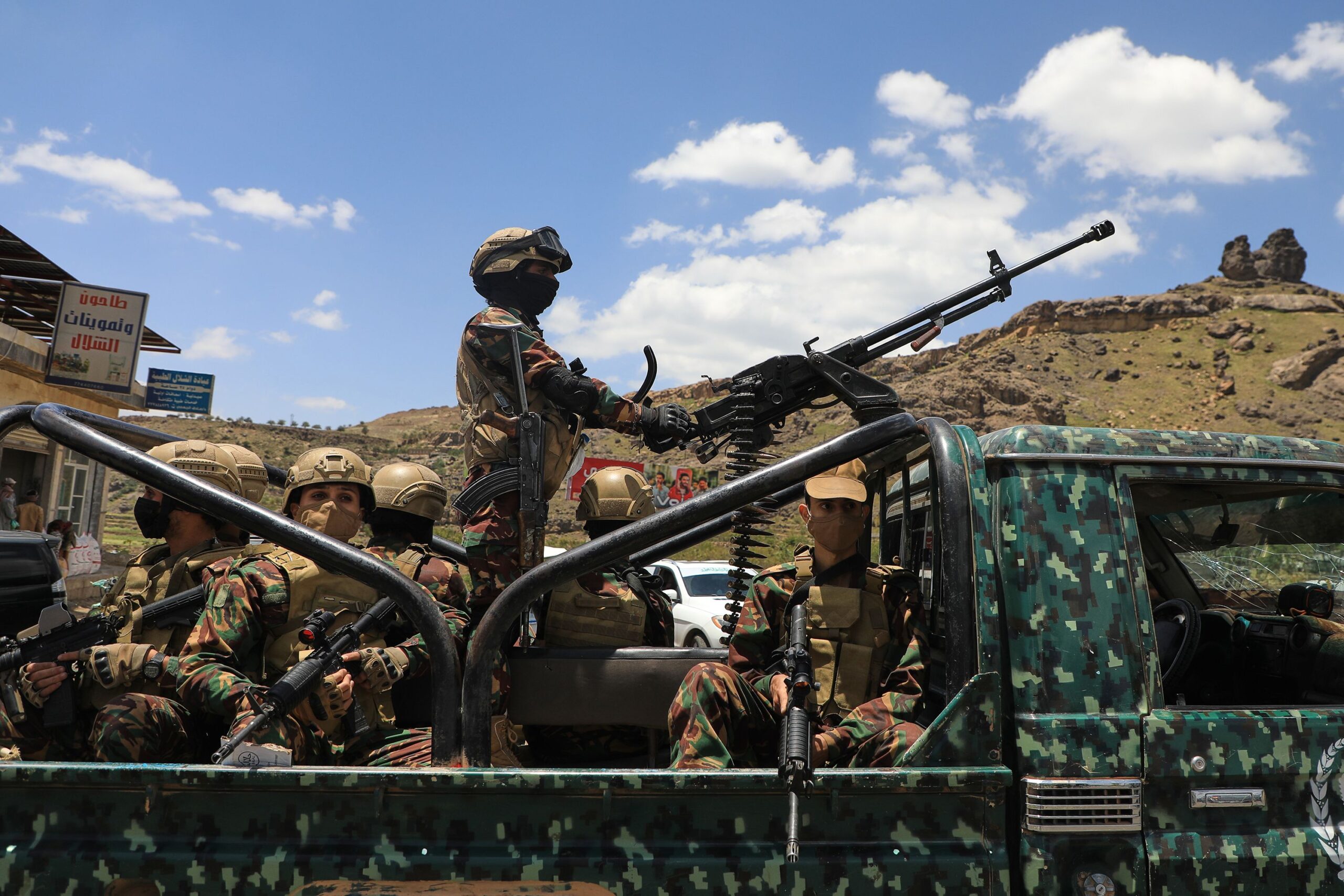 <i>Stringer/AP via CNN Newsource</i><br/>Houthi fighters escort a convoy carrying prisoners freed in Mokha through the Bani Matar district on its way to Sanaa