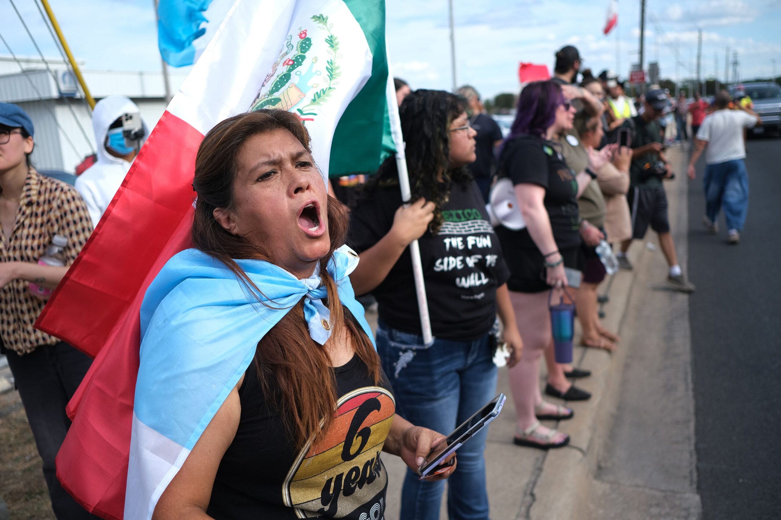 <i>Joel Angel Juarez/AP via CNN Newsource</i><br/>People protest where local authorities say a US Immigration and Customs Enforcement officer shot and wounded a man in Austin