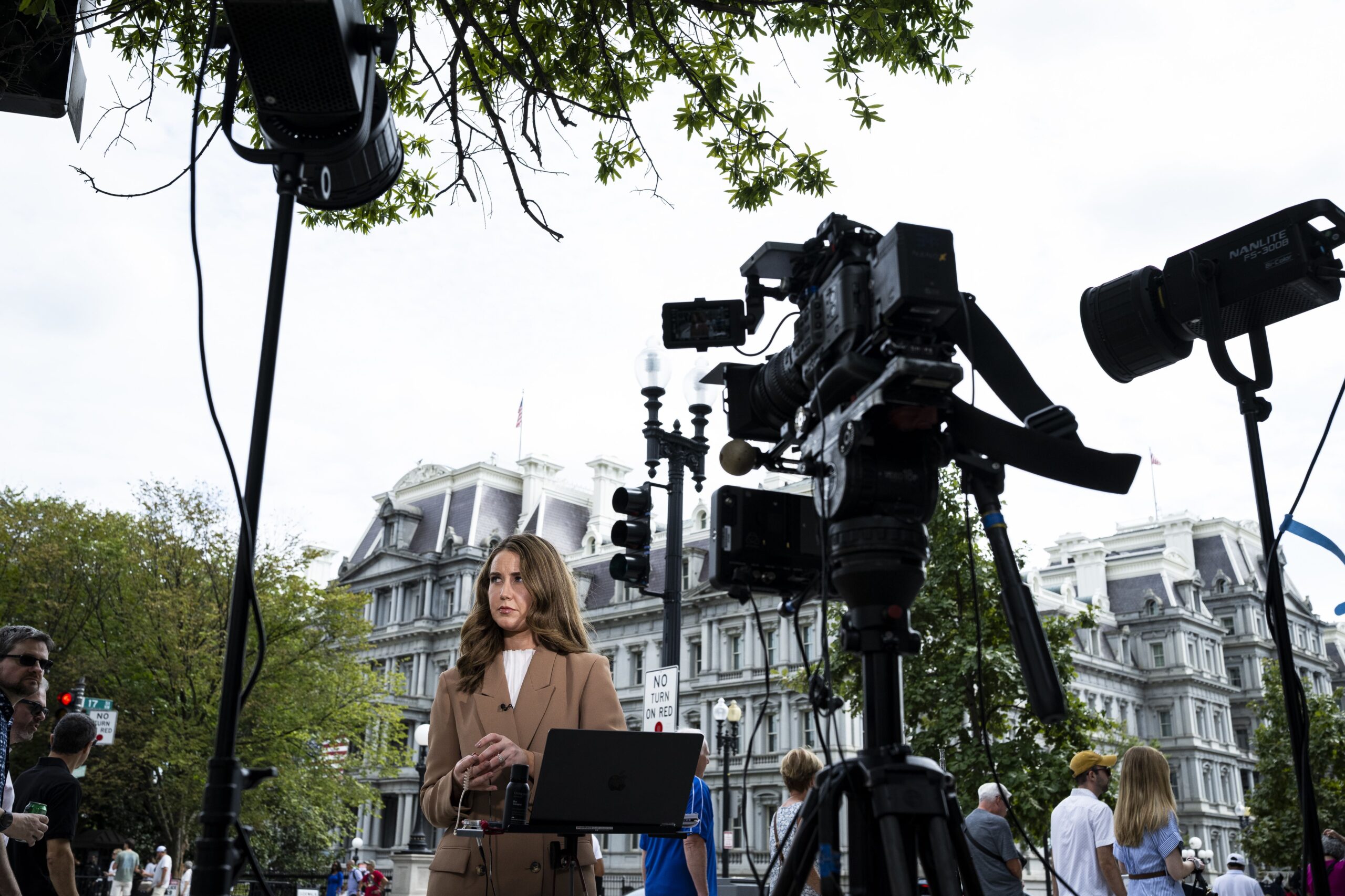 <i>Graeme Sloan/Getty Images via CNN Newsource</i><br/>CNN Correspondent Julia Benbrook prepares for a television report on a street corner outside the White House grounds after earlier being denied entry