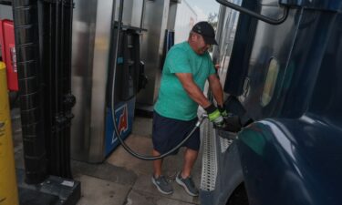 A person pumps diesel fuel into his tractor-trailer at a truck stop on September 11