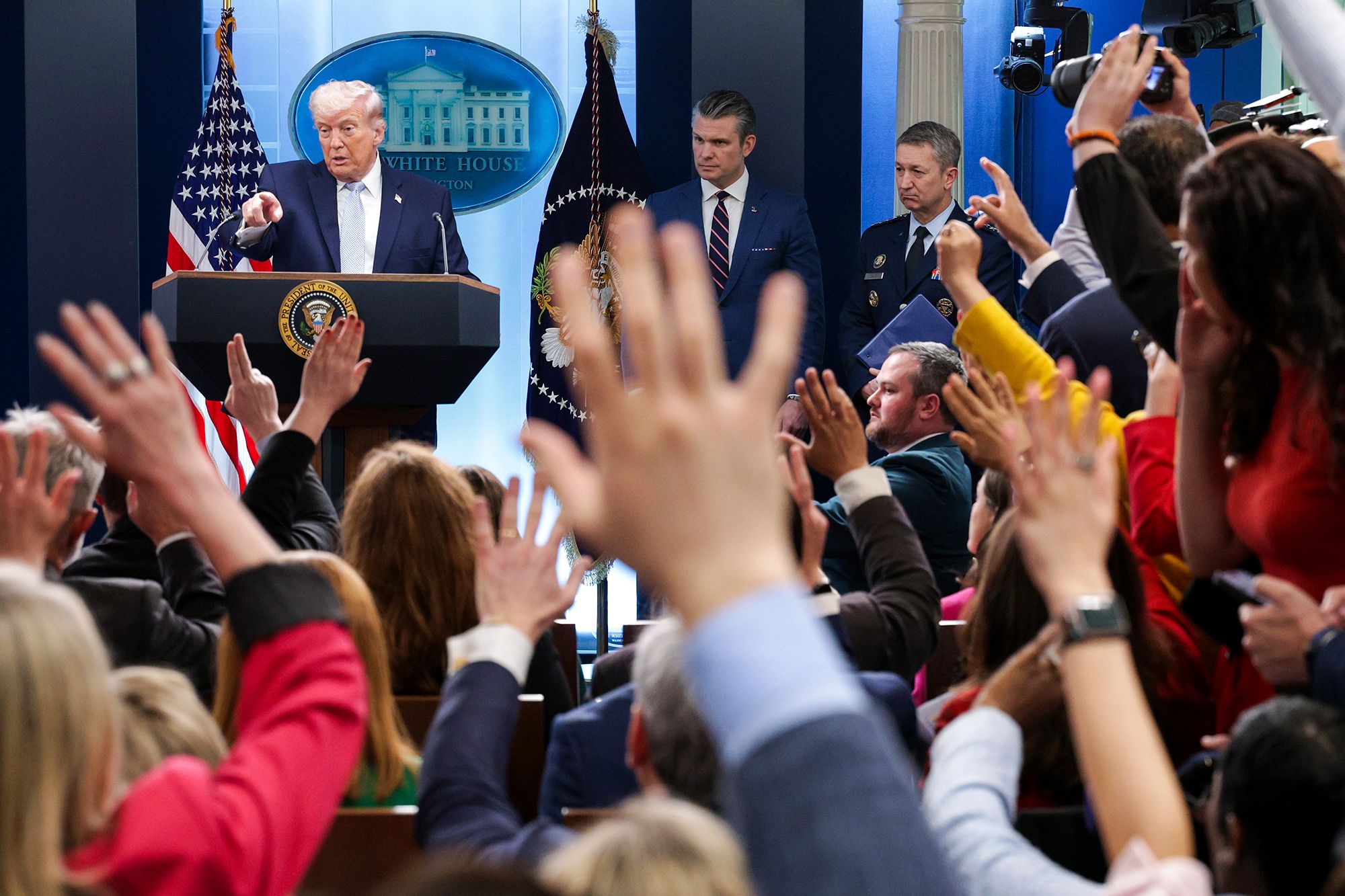 <i>Alex Wong/Getty Images via CNN Newsource</i><br/>US President Donald Trump answers questions alongside US Secretary of Defense Pete Hegseth  and Chairman of the Joint Chiefs of Staff General Dan Caine during a news conference in the White House on April 6.