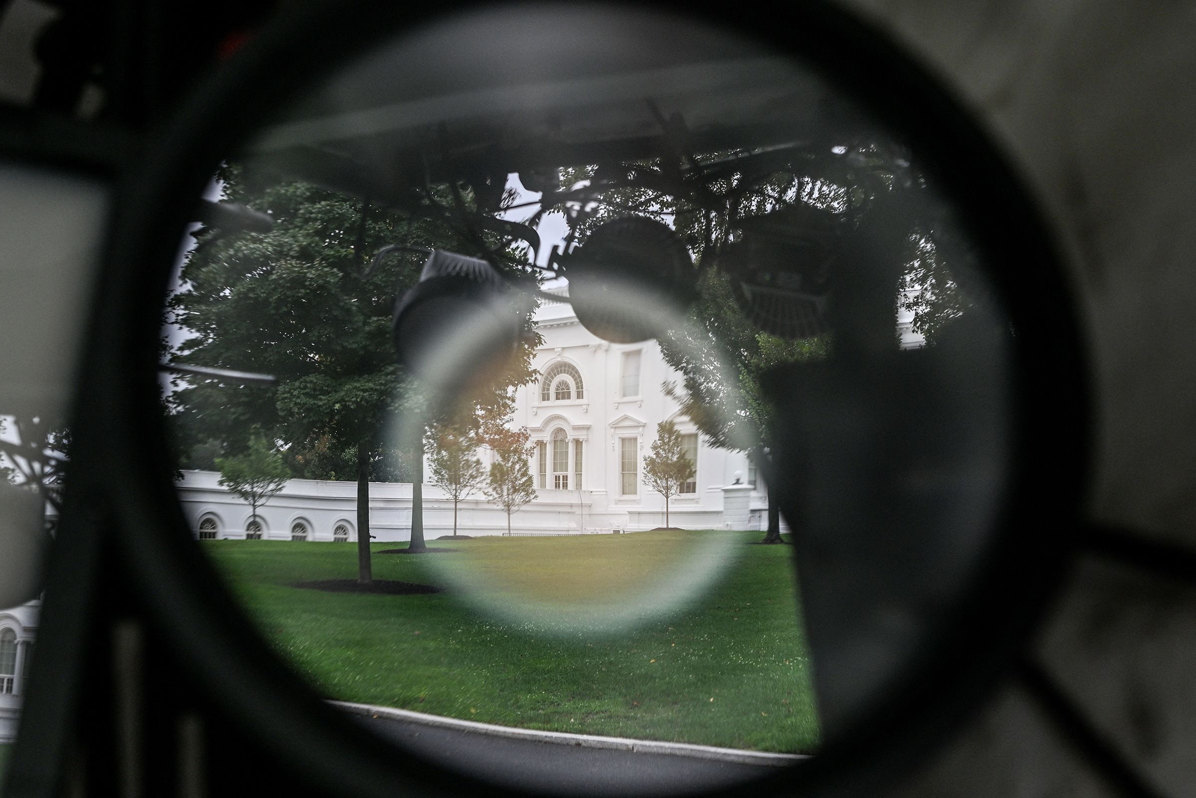 <i>Alex Wroblewski/AFP/Getty Images via CNN Newsource</i><br/>The White House is seen reflected in equipment hanging inside CNN's workspace on the grounds of the White House