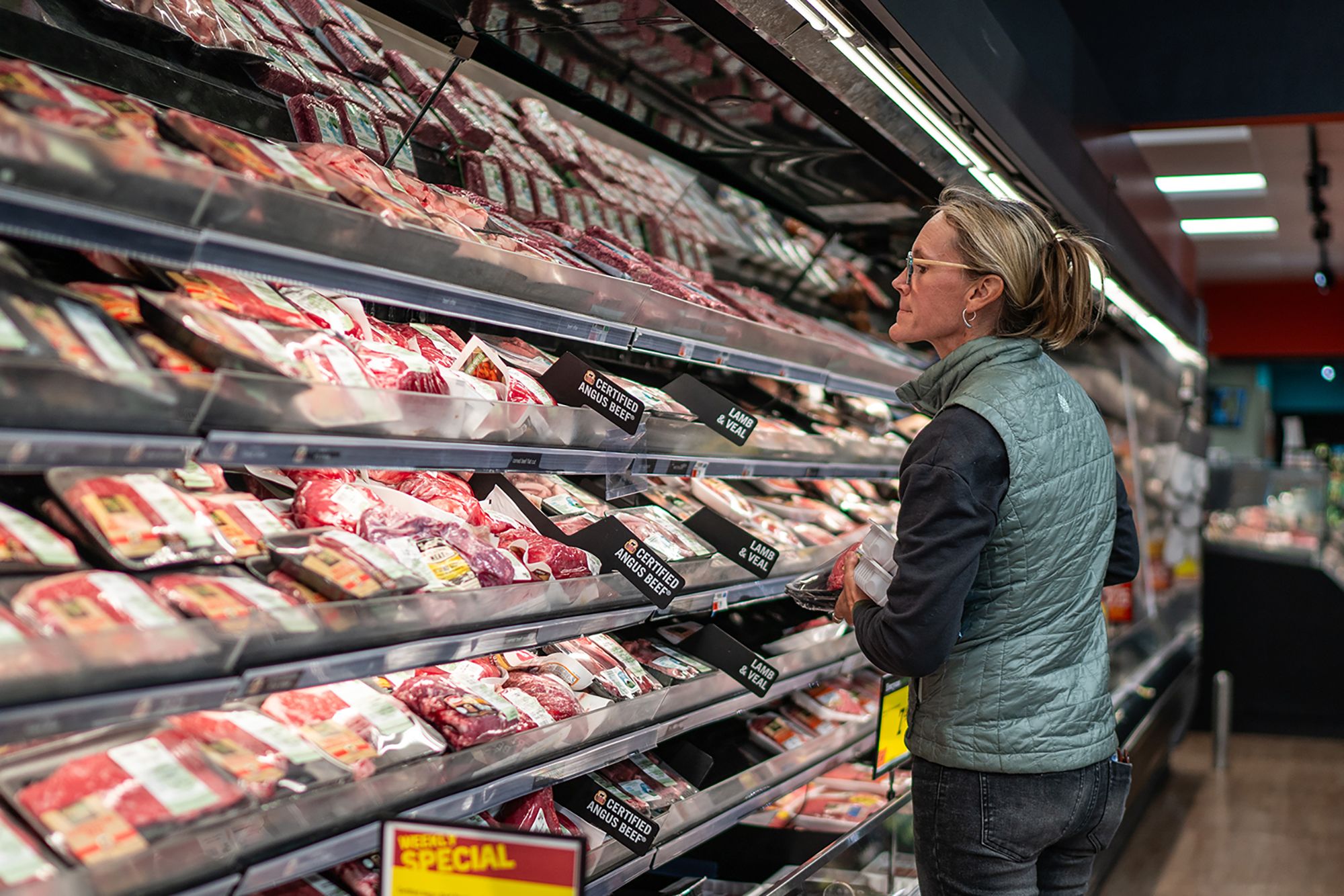 <i>Robert Nickelsberg/Getty Images via CNN Newsource</i><br/>A local shopper searches for meat products at a supermarket in South Burlington