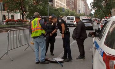 Law enforcement investigate a manhole where three individuals were seen exiting the sewers near Netanyahu's hotel on September 25 in New York.