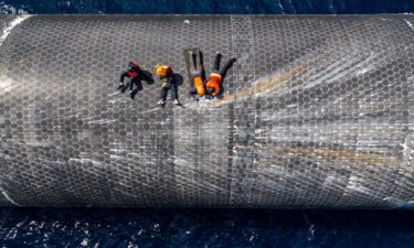 This image provided by SpaceX on August 27 shows engineers inspecting Starship off the coast of Christmas Island in the Indian Ocean