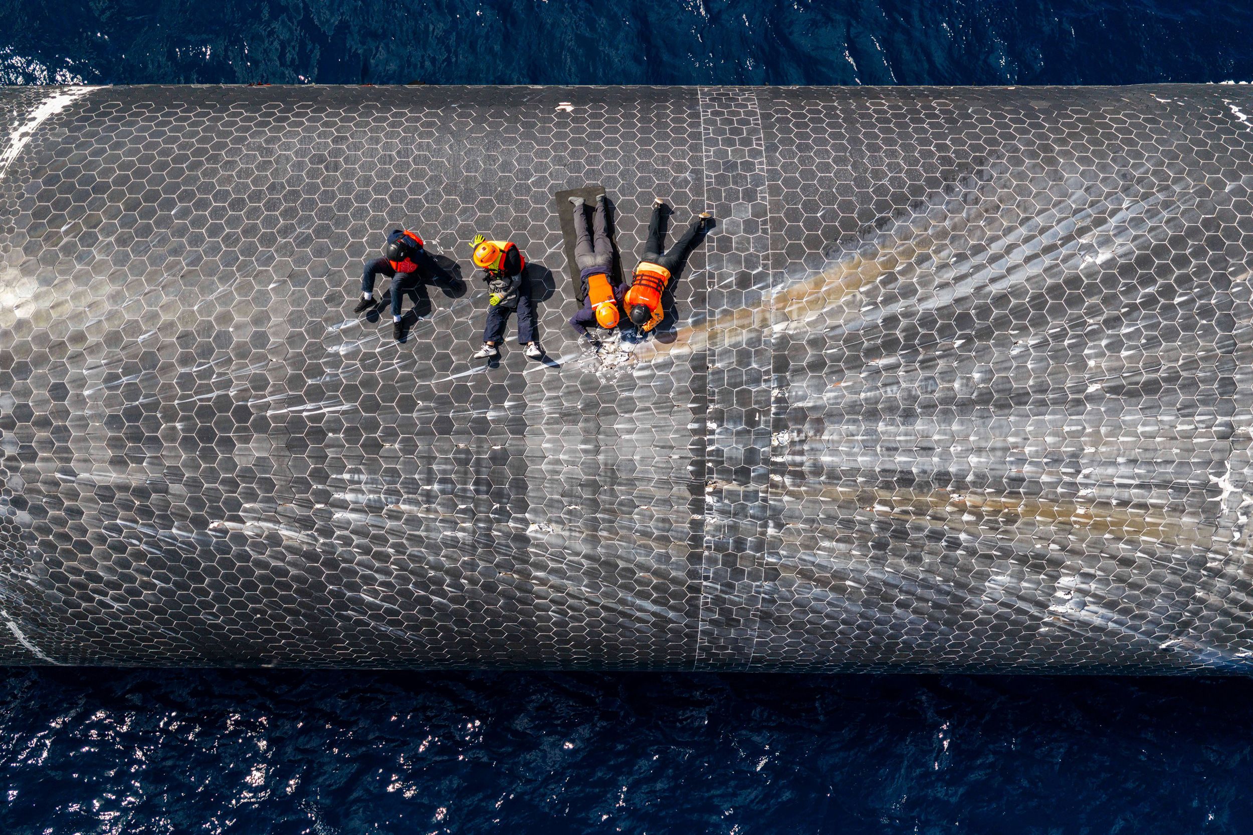 <i>SpaceXAP via CNN Newsource</i><br/>This image provided by SpaceX on August 27 shows engineers inspecting Starship off the coast of Christmas Island in the Indian Ocean