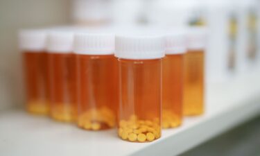 Medications are stored on shelves at a pharmacy.